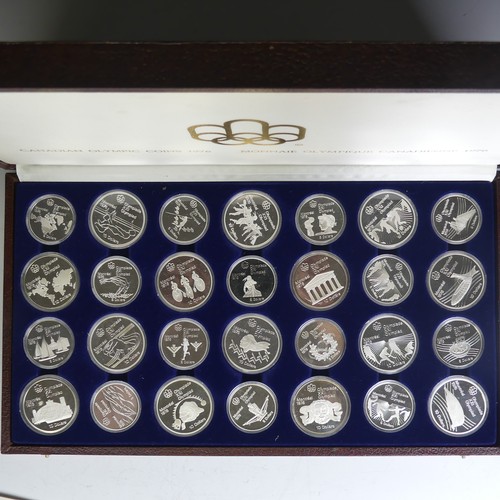 323 - A cased 1976 Canadian Olympics silver proof Coin Set, of twenty-eight coins, fourteen $10 coins and ... 