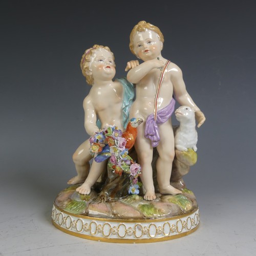A 19thC Meissen porcelain Group, modelled as a pair of Cupids with parrot and a lamb, missing an ear, with floral relief work, bucket broken, raised on gilded plinth, underglaze blue crossed swords mark to base also incised H90, H 16.5cm.
