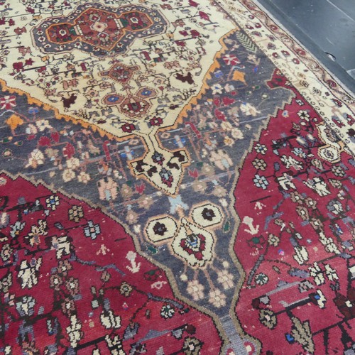 603 - Tribal Rugs; a large Persian Qashqai Rug, red, cream and grey ground with all over typical patterns,... 