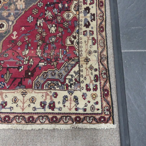 603 - Tribal Rugs; a large Persian Qashqai Rug, red, cream and grey ground with all over typical patterns,... 