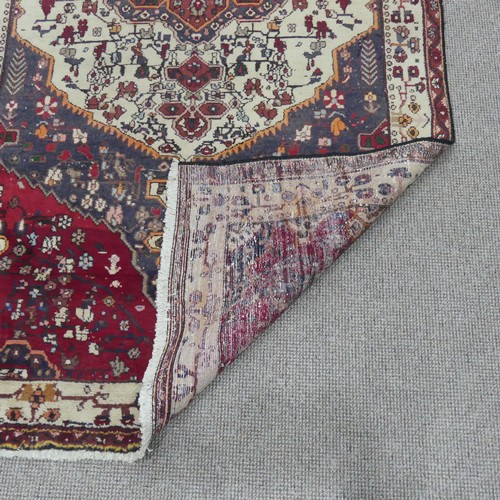 603 - Tribal Rugs; a large Persian Qashqai Rug, red, cream and grey ground with all over typical patterns,... 