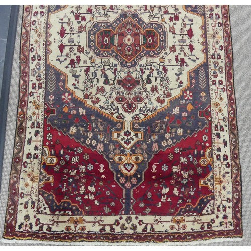 603 - Tribal Rugs; a large Persian Qashqai Rug, red, cream and grey ground with all over typical patterns,... 