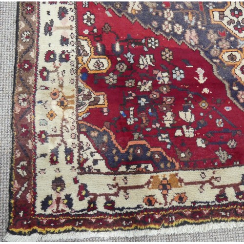 603 - Tribal Rugs; a large Persian Qashqai Rug, red, cream and grey ground with all over typical patterns,... 