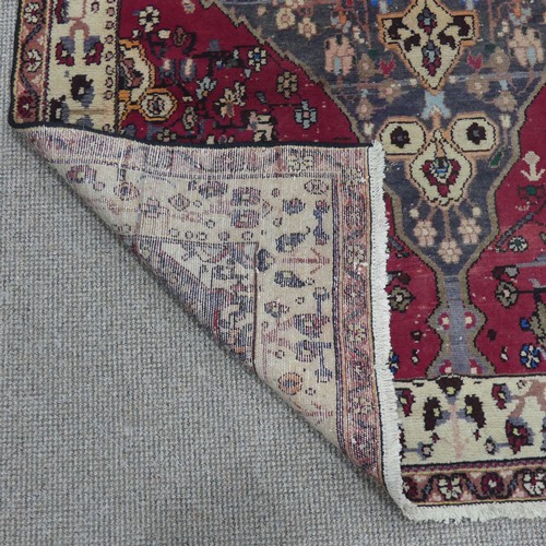 603 - Tribal Rugs; a large Persian Qashqai Rug, red, cream and grey ground with all over typical patterns,... 