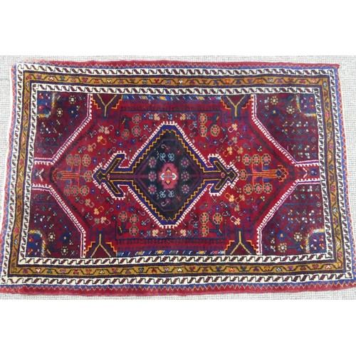 604 - Tribal Rugs; a Persian Qashqai Rug, red ground, thick wool pile on cotton base, worn along one edge,... 