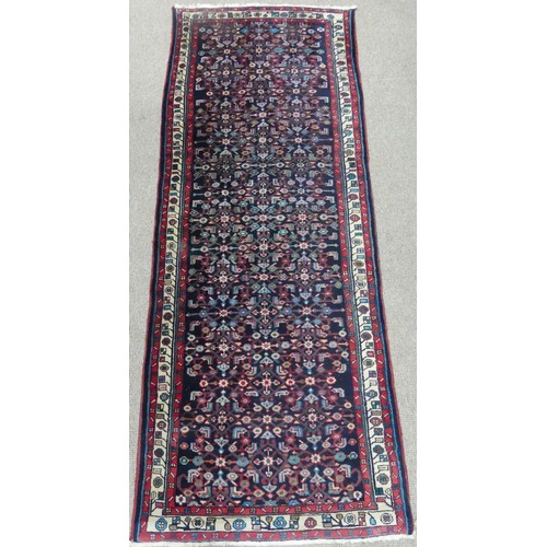 606 - Tribal Rugs; a Persian Herati Runner, very dark navy ground, wool pile on cotton base, 293cm x 113cm... 