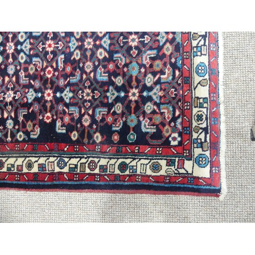 606 - Tribal Rugs; a Persian Herati Runner, very dark navy ground, wool pile on cotton base, 293cm x 113cm... 