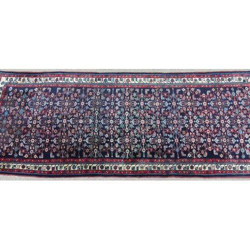 606 - Tribal Rugs; a Persian Herati Runner, very dark navy ground, wool pile on cotton base, 293cm x 113cm... 