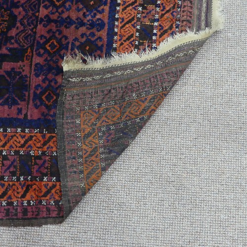 608 - Tribal Rugs; an old Afghan Rug, plum coloured ground with geometric patterned dark orange border, ti... 