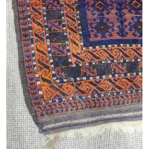 608 - Tribal Rugs; an old Afghan Rug, plum coloured ground with geometric patterned dark orange border, ti... 