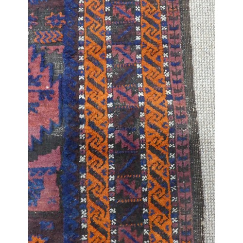 608 - Tribal Rugs; an old Afghan Rug, plum coloured ground with geometric patterned dark orange border, ti... 