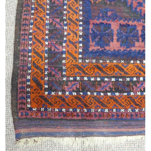 608 - Tribal Rugs; an old Afghan Rug, plum coloured ground with geometric patterned dark orange border, ti... 