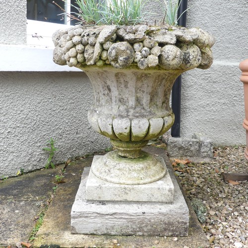 618 - A Pair of weathered stoneware garden Urns, with moulded floral borders, raised on plinth base, W 58 ... 