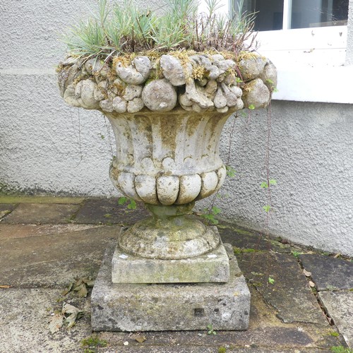 618 - A Pair of weathered stoneware garden Urns, with moulded floral borders, raised on plinth base, W 58 ... 