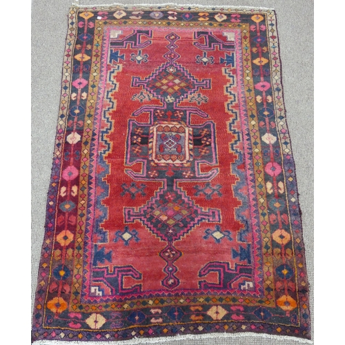 614 - Tribal Rugs; an old Caucasian Rug, red ground with three central medallions within a geometric patte... 