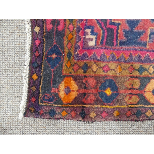 614 - Tribal Rugs; an old Caucasian Rug, red ground with three central medallions within a geometric patte... 