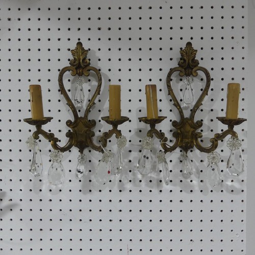 578 - A pair of early 20thC gilt brass two branch Wall Sconces, adorned with crystal glass drops, H34cm x ... 