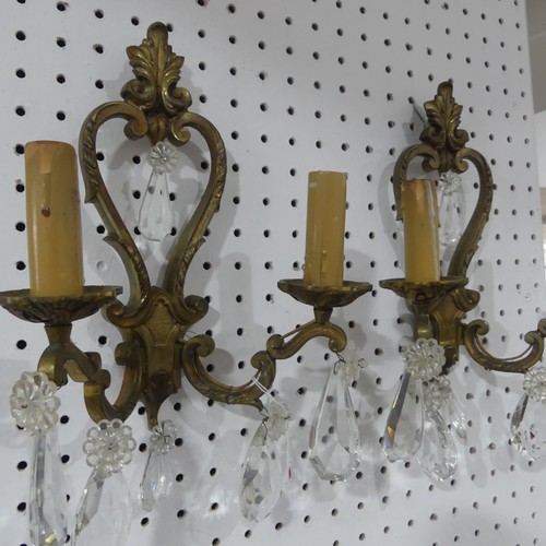 578 - A pair of early 20thC gilt brass two branch Wall Sconces, adorned with crystal glass drops, H34cm x ... 