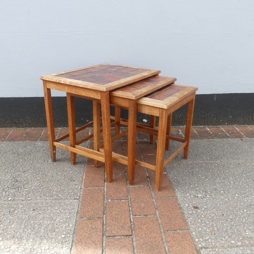 600 - Mid-20th century nest of three teak-framed tile-top tables, largest W:56cm x D:40.5cm x H:48cm, smal... 