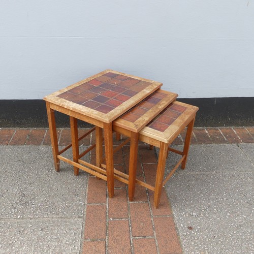 600 - Mid-20th century nest of three teak-framed tile-top tables, largest W:56cm x D:40.5cm x H:48cm, smal... 