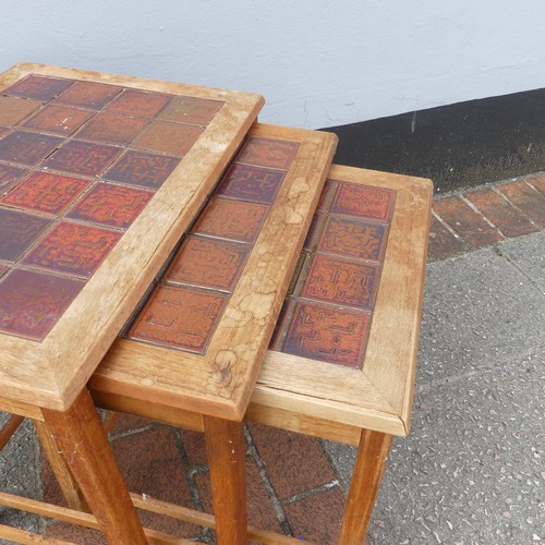 600 - Mid-20th century nest of three teak-framed tile-top tables, largest W:56cm x D:40.5cm x H:48cm, smal... 