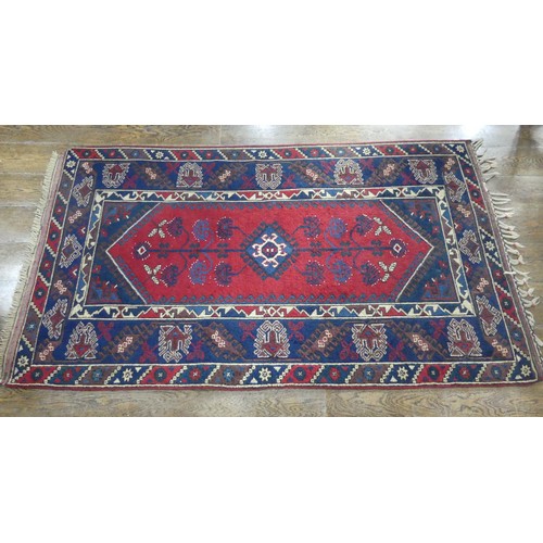 615 - Tribal Rugs; a Turkish Rug, blue and red ground with tree of life patterns set within a geometric pa... 