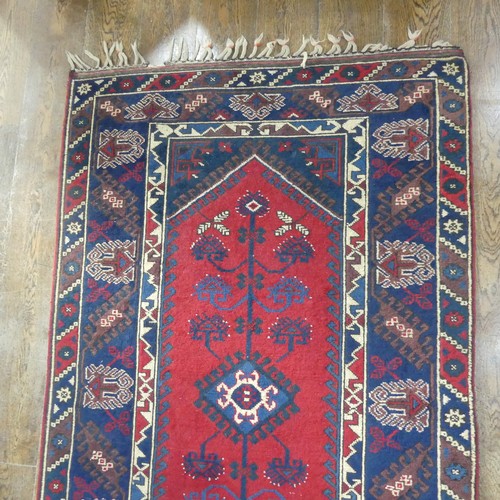 615 - Tribal Rugs; a Turkish Rug, blue and red ground with tree of life patterns set within a geometric pa... 