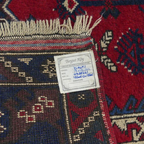 615 - Tribal Rugs; a Turkish Rug, blue and red ground with tree of life patterns set within a geometric pa... 