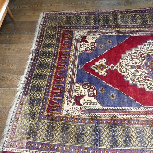 617 - Tribal Rugs; an old Turkish Yahyali Rug, blue and red ground with cream central medallion, within a ... 