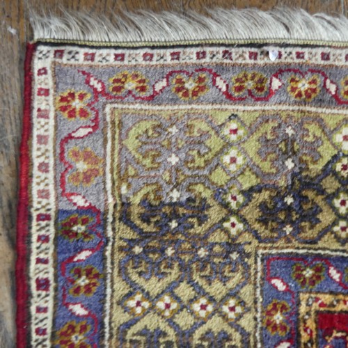 617 - Tribal Rugs; an old Turkish Yahyali Rug, blue and red ground with cream central medallion, within a ... 