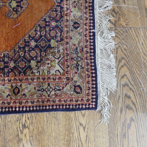 613 - Tribal Rugs; an old Persian finely knotted 100% silk rug, burnt orange ground with dark blue border ... 