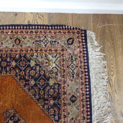 613 - Tribal Rugs; an old Persian finely knotted 100% silk rug, burnt orange ground with dark blue border ... 