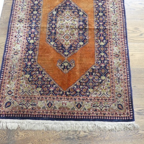 613 - Tribal Rugs; an old Persian finely knotted 100% silk rug, burnt orange ground with dark blue border ... 