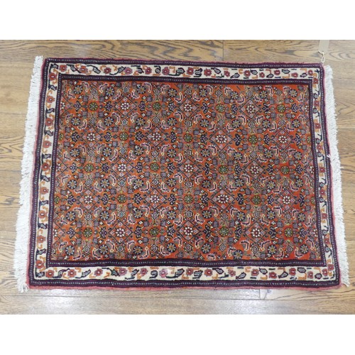 607 - Tribal Rugs; a small dark rust ground Persian Herati rug, of high quality, with finely knotted wool ... 