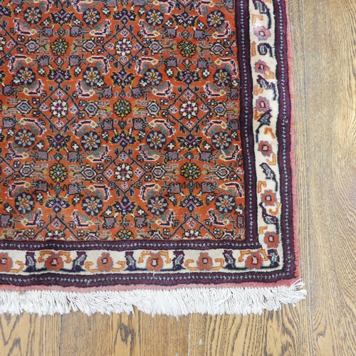 607 - Tribal Rugs; a small dark rust ground Persian Herati rug, of high quality, with finely knotted wool ... 