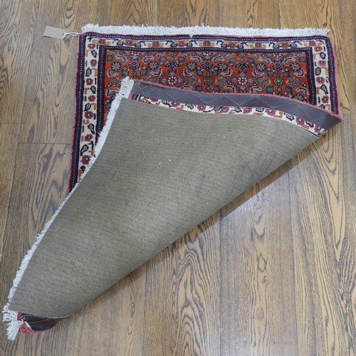 607 - Tribal Rugs; a small dark rust ground Persian Herati rug, of high quality, with finely knotted wool ... 