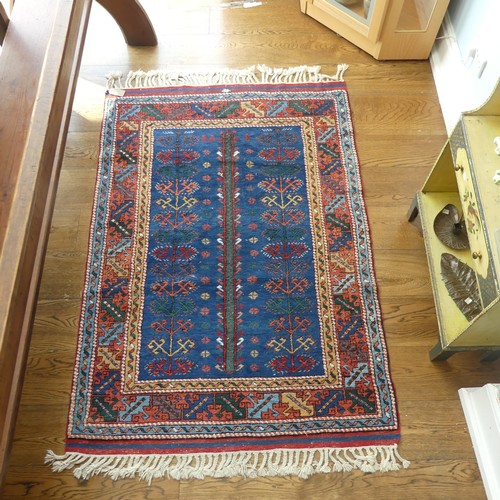 610 - Tribal Rugs; a blue ground Caucasian Rug, with tree of life designs and geometric patterned borders ... 