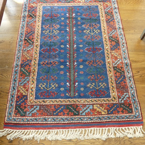 610 - Tribal Rugs; a blue ground Caucasian Rug, with tree of life designs and geometric patterned borders ... 