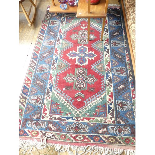 602 - Tribal Rugs: an old Turkish hand knotted wool rug, the whole woven with bold geometric patterns in d... 