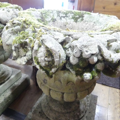 618 - A Pair of weathered stoneware garden Urns, with moulded floral borders, raised on plinth base, W 58 ... 