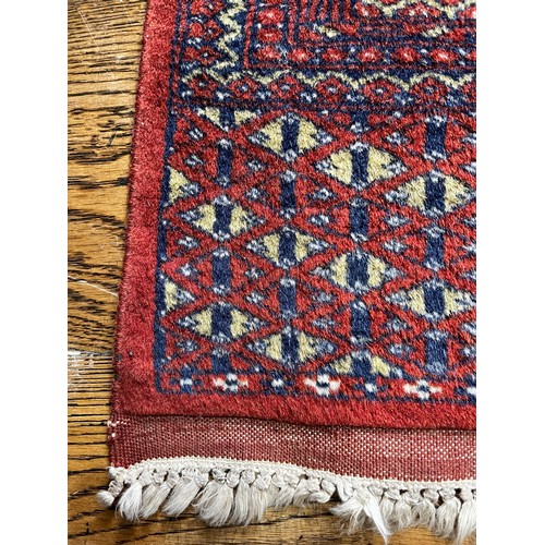 517 - Tribal Rugs; a fine hand-knotted old Turkomen Bokhara rug, short wool pile on silk base, the salmon ... 