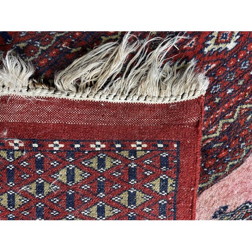 517 - Tribal Rugs; a fine hand-knotted old Turkomen Bokhara rug, short wool pile on silk base, the salmon ... 