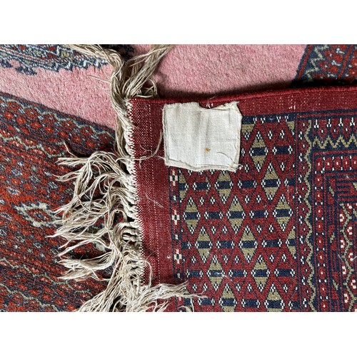 517 - Tribal Rugs; a fine hand-knotted old Turkomen Bokhara rug, short wool pile on silk base, the salmon ... 