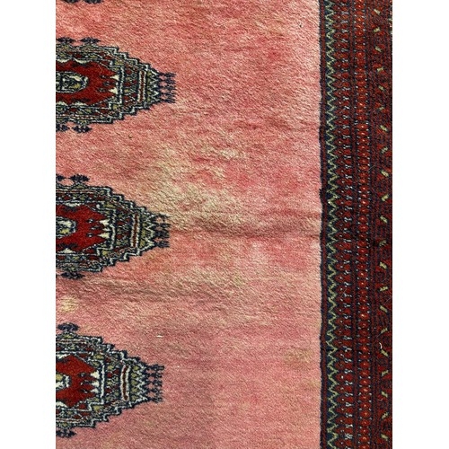 517 - Tribal Rugs; a fine hand-knotted old Turkomen Bokhara rug, short wool pile on silk base, the salmon ... 