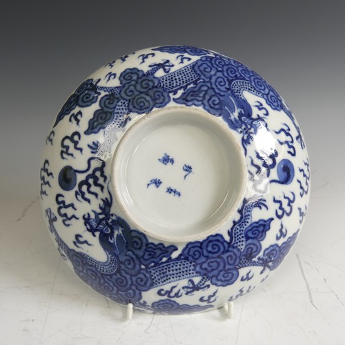 91 - An antique Chinese blue and white porcelain Footed Dish, decorated underglaze with dragons, with fou... 