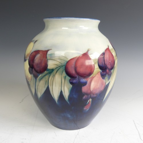 4 - A William Moorcroft 'Wisteria' pattern Globular Vase, with typical tubelined decoration on blue grou... 