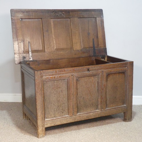 384 - An 18thC panelled oak Coffer, raised on square feet, W 109 cm x H 66 cm x D 56 cm.