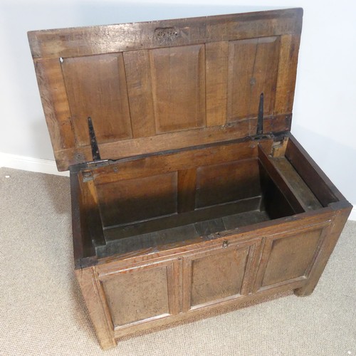 384 - An 18thC panelled oak Coffer, raised on square feet, W 109 cm x H 66 cm x D 56 cm.