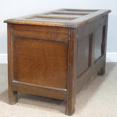 384 - An 18thC panelled oak Coffer, raised on square feet, W 109 cm x H 66 cm x D 56 cm.