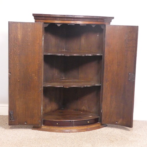 390 - A Georgian oak bow-front wall Corner Cupboard, W 70 cm x H 98 cm x D 47 cm.